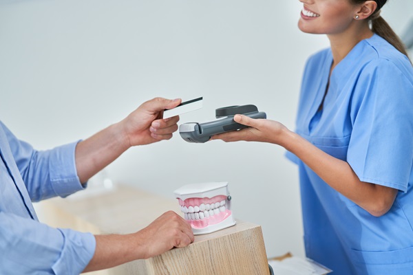 Patient paying for dental visit in clinic