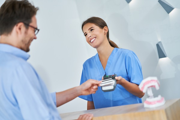 Patient paying for dental visit in clinic