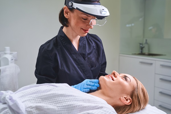 Positive delighted cosmetologist consulting her young client